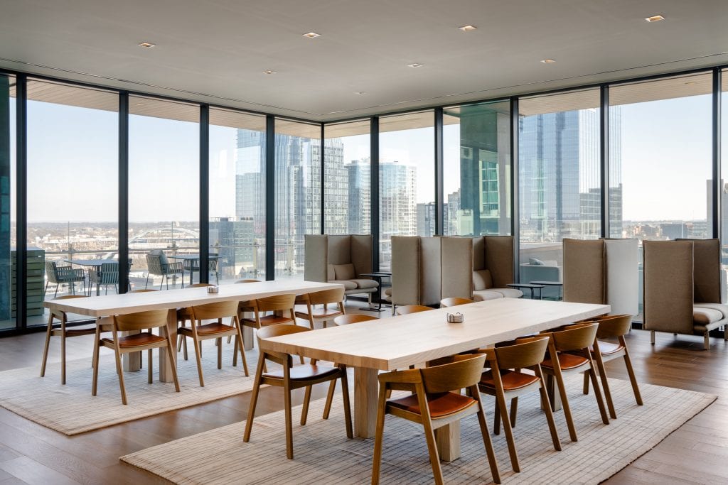 Alliance Bernstein 8 Dining and lounge area featuring wooden tables, floor-to-ceiling windows, and contemporary decor.