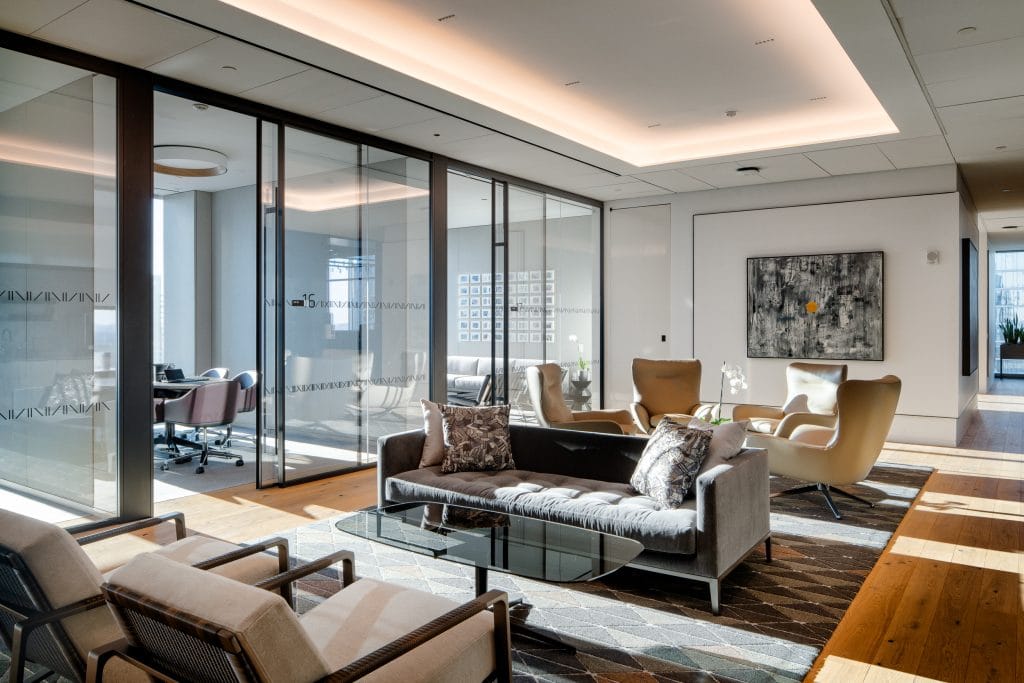 Alliance Bernstein 17 Executive lounge with modern furniture, warm lighting, and views of the Nashville skyline.
