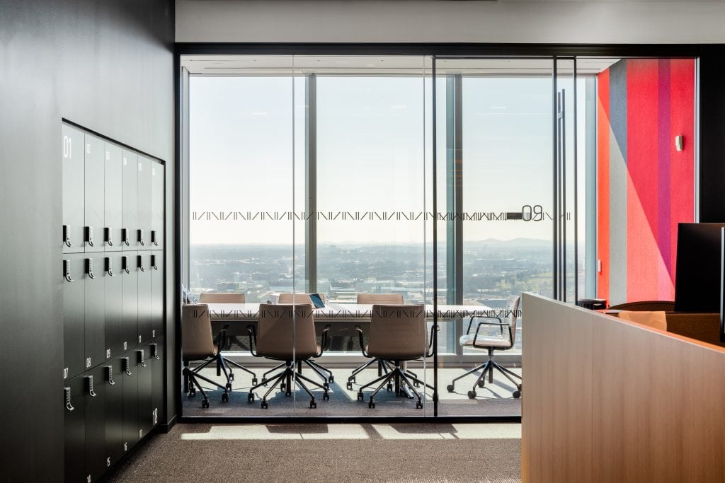 Alliance Bernstein 18 Glass-enclosed meeting room featuring modern chairs, bright natural light, and skyline views.