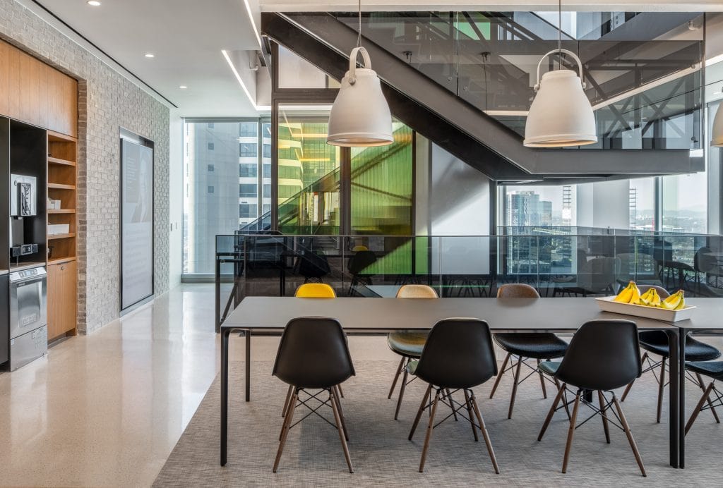 Alliance Bernstein 11 Office break room with modern furnishings, pendant lighting, and a glass staircase, Nashville, TN.