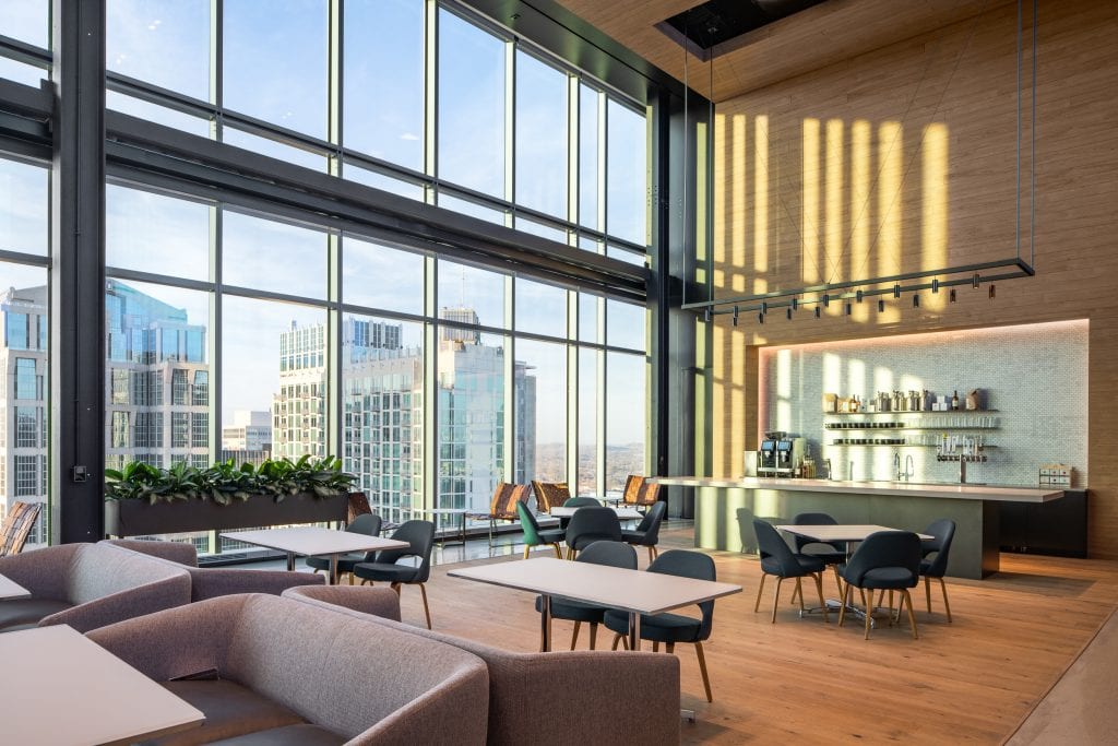 Alliance Bernstein 14 Office cafe featuring floor-to-ceiling windows, contemporary furniture, and skyline views of Nashville.