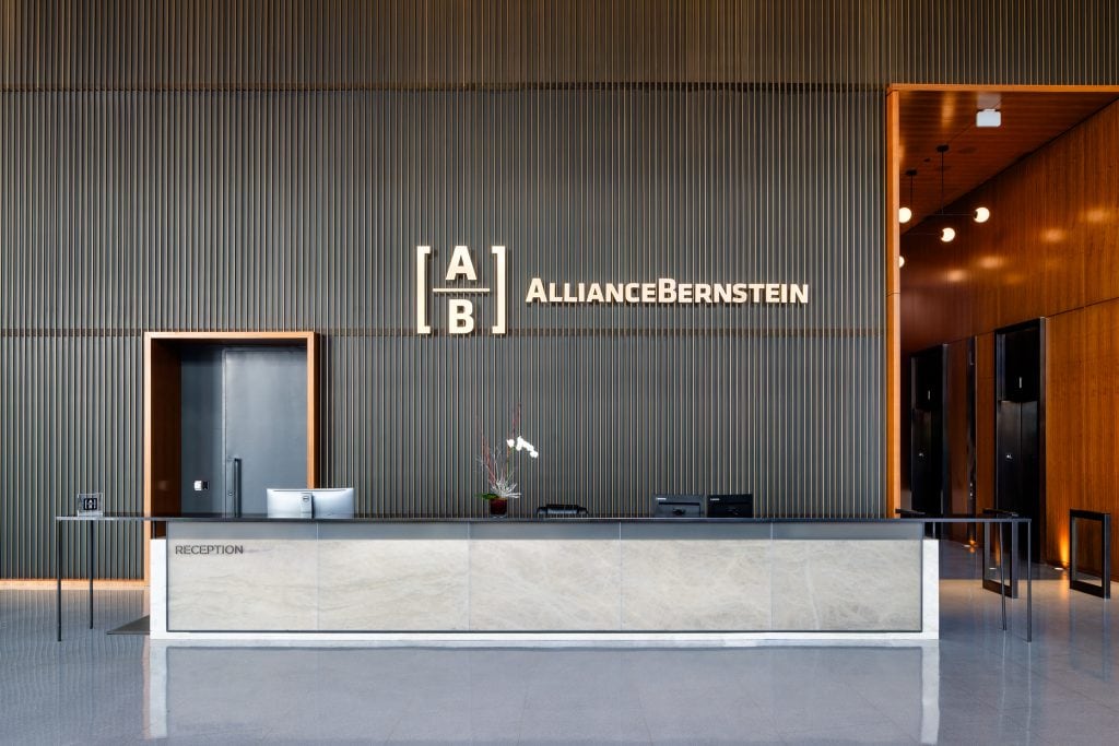 Alliance Bernstein 5 Sleek reception desk in a contemporary Nashville office lobby with wood and metal accents.