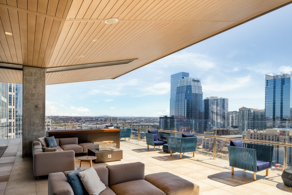 Alliance Bernstein 24 Rooftop terrace with comfortable seating, a firepit, and panoramic skyline views of downtown Nashville.