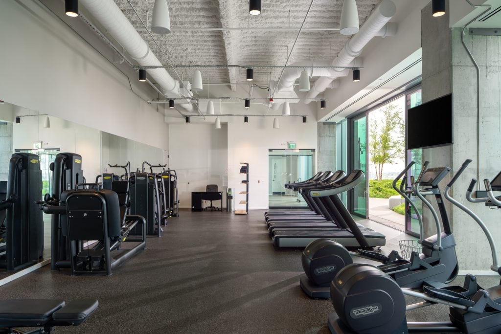 Alliance Bernstein 21 Contemporary fitness center with treadmills, weight machines, and natural light overlooking Nashville, TN.