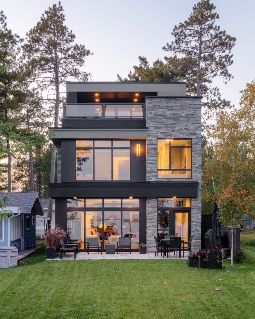 LAKESIDE CONTEMPORARY 13 Modern home exterior with stone accents and large windows in Bemidji, Minnesota.