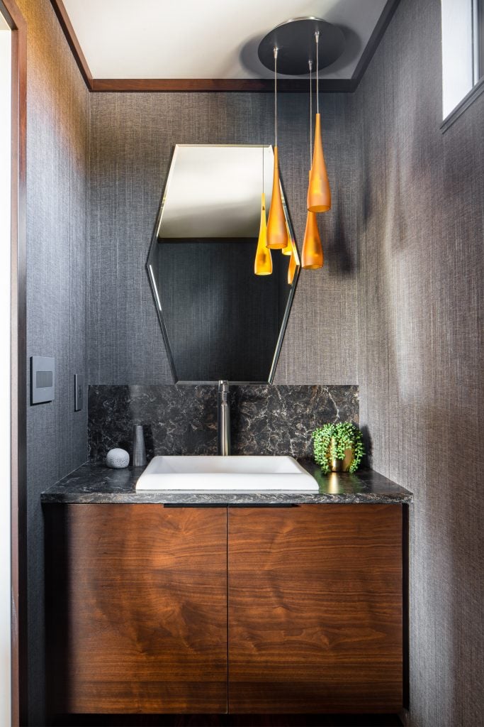 LAKESIDE CONTEMPORARY 10 Modern powder room with statement lighting and wood cabinetry.