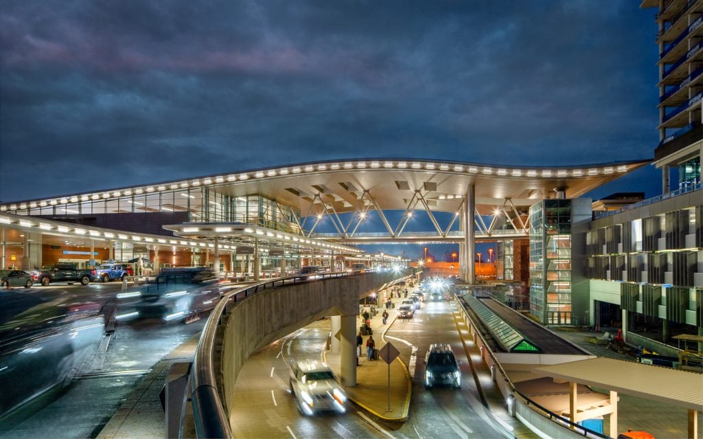 BNA - Nashville Airport 16 Nighttime view of Nashville International Airport terminal with illuminated traffic and architectural design.