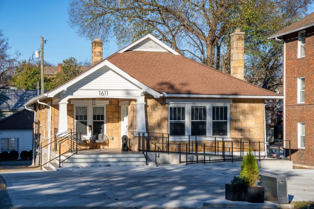 Bangarang 1 Renovated historic exterior of a building with stone facade and modern ramp.