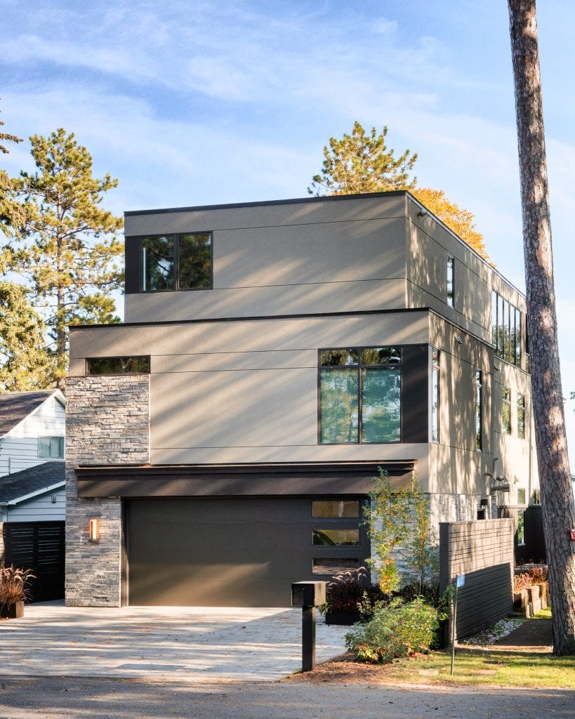 LAKESIDE CONTEMPORARY 2 Side facade of a modern lake home with clean lines and natural materials.