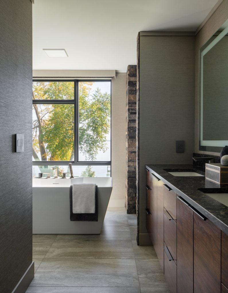 LAKESIDE CONTEMPORARY 9 Modern powder room with statement lighting and wood cabinetry.