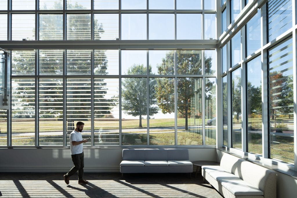 UKC COLDSTREAM 6 Bright seating area with natural light streaming through glass windows.