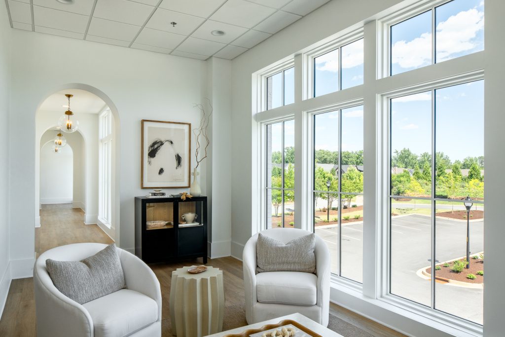 Brio 7 Bright lounge with large windows and contemporary furniture.