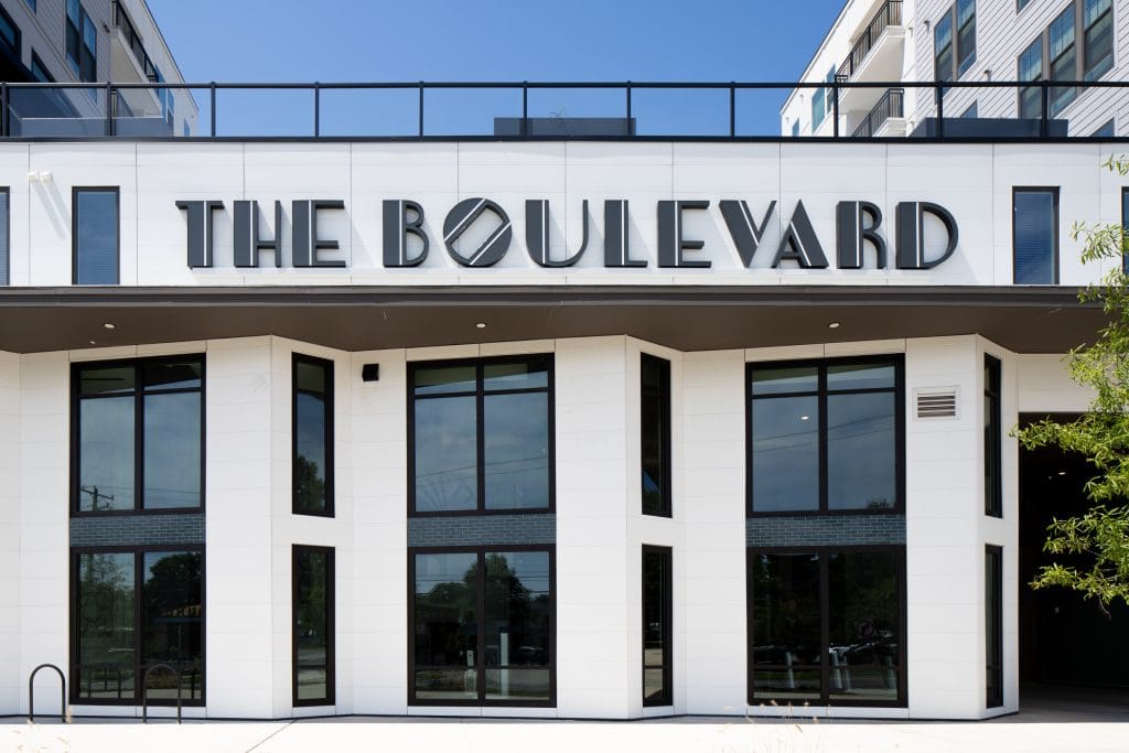 THE BOULEVARD 2 Modern building facade with large windows and "The Boulevard" signage.