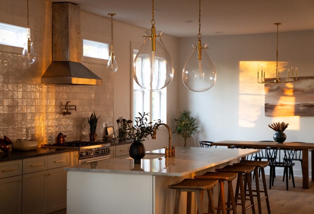 Eastside 8 Dining room with large island and golden lighting.