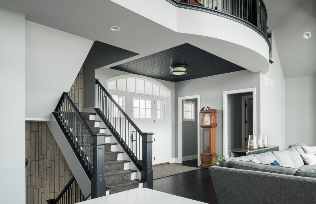 Crystal Lake 1 Entryway with black staircase and arched doorway.