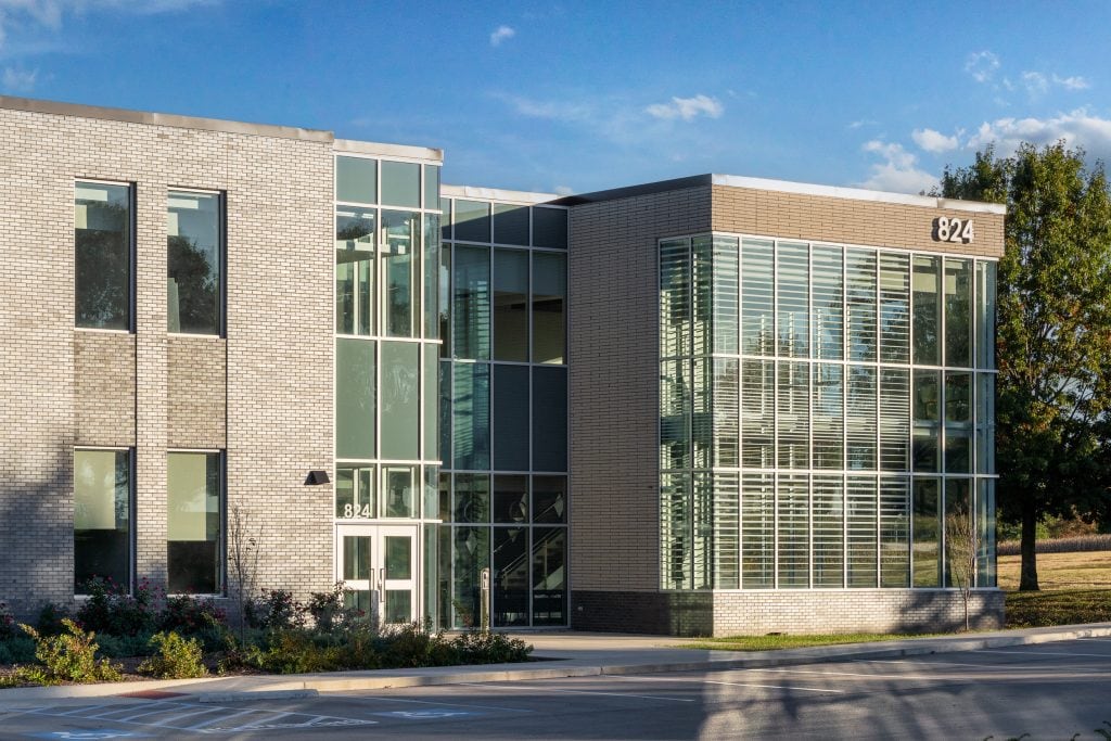 UKC COLDSTREAM 3 Interior commons area with large glass windows and natural light.