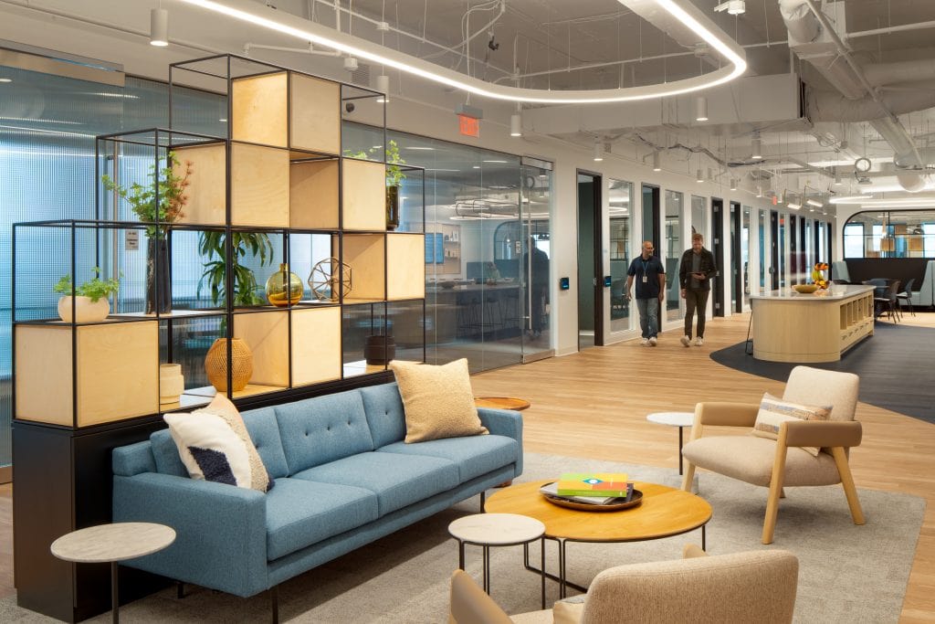 Capgemini Atlanta 3 Comfortable office lounge with wooden accents and open hallway.