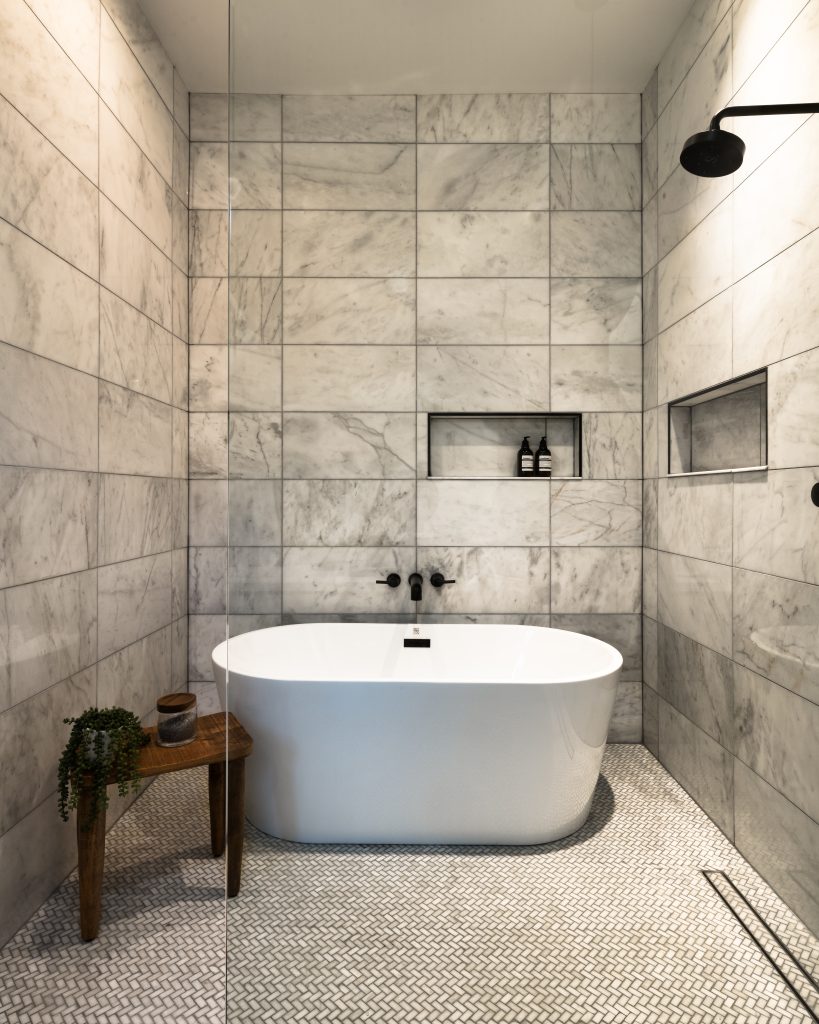 Eastside 6 Luxury bathroom with white marble and freestanding tub.