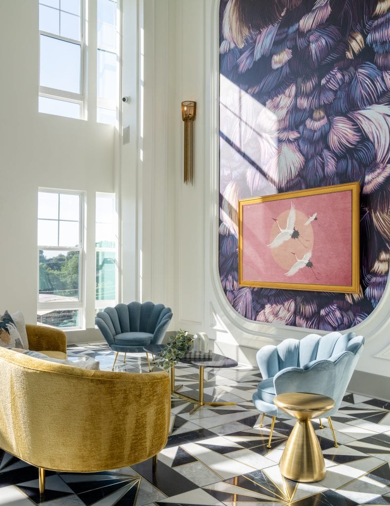 THE BOULEVARD 10 Luxury lounge with geometric flooring, decorative lighting, and velvet seating.