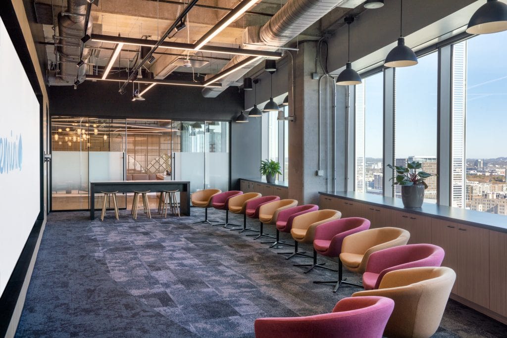 Capgemini Nashville 2 Modern conference room with colorful chairs and city views.