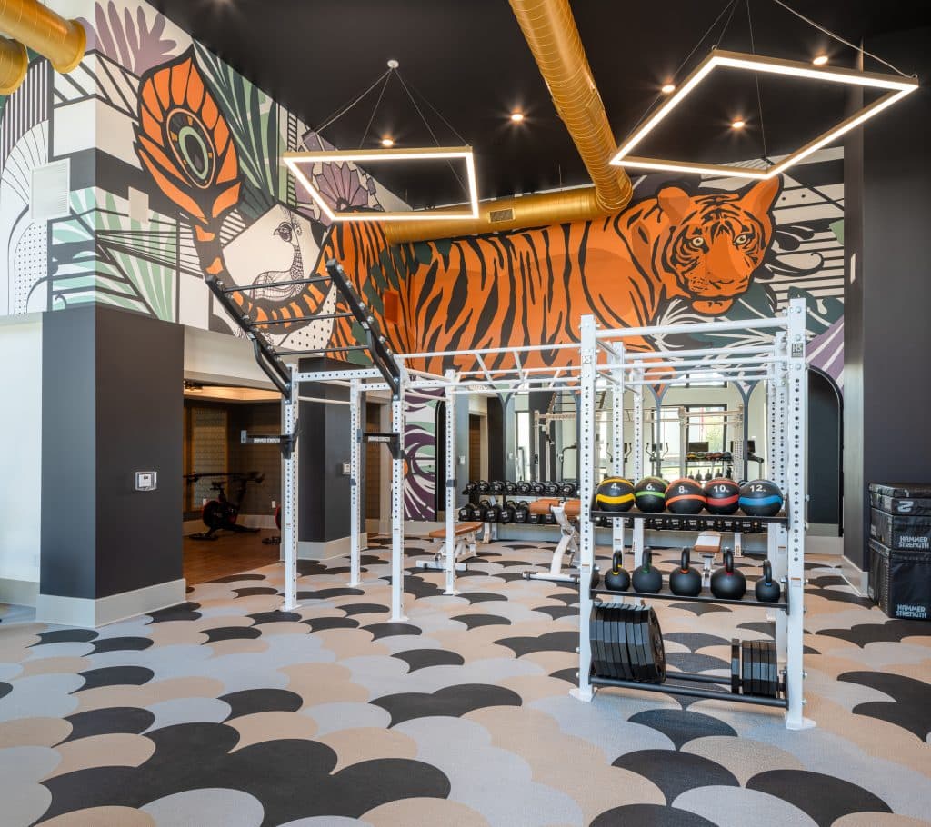 THE BOULEVARD 5 Modern gym with vibrant tiger mural, abstract designs, and state-of-the-art equipment.