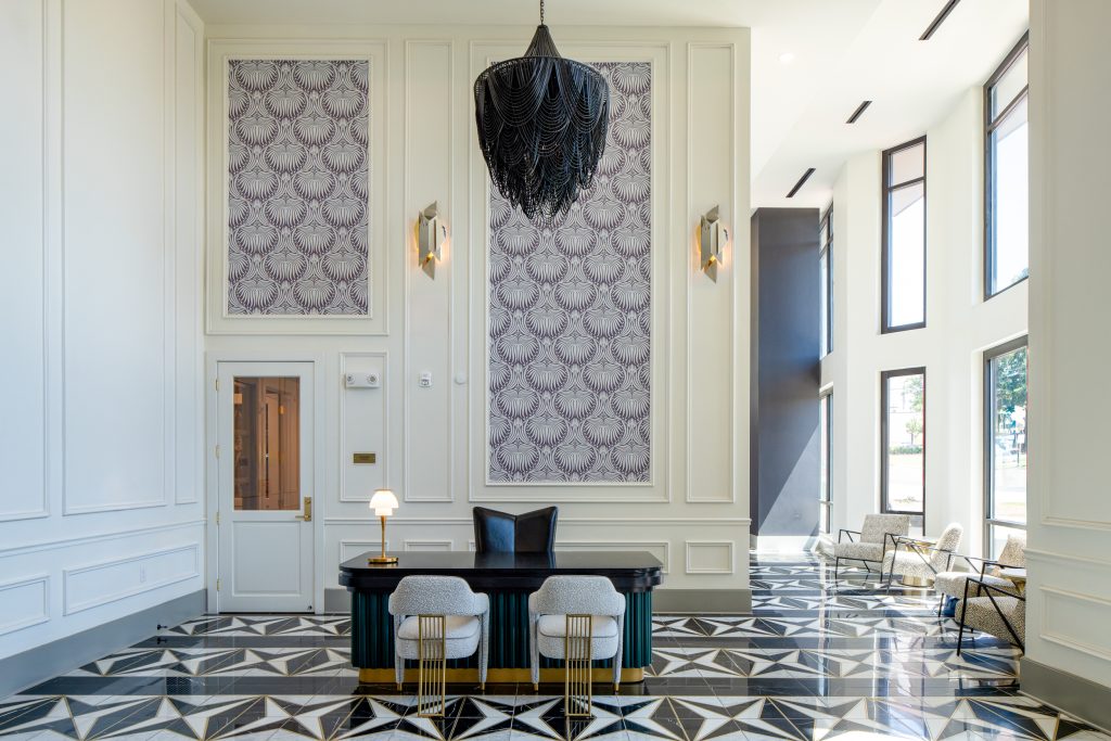THE BOULEVARD 4 Modern lobby with black chandelier, bright natural light, and elegant seating.