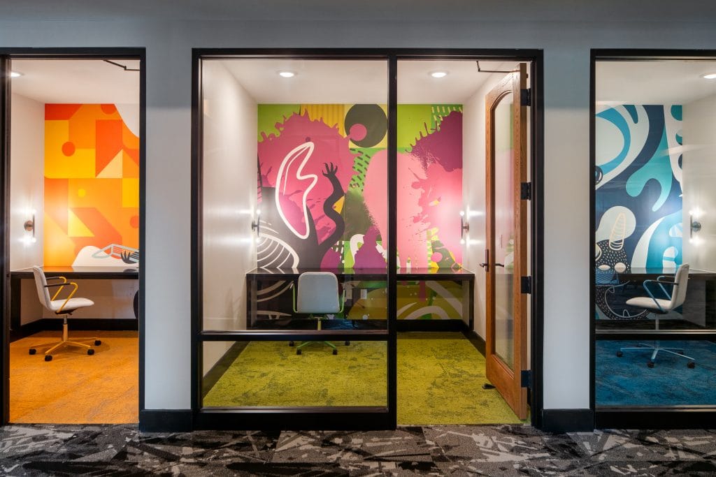 Broadstone Craft 12 Private workspaces with vibrant murals and modern furniture.