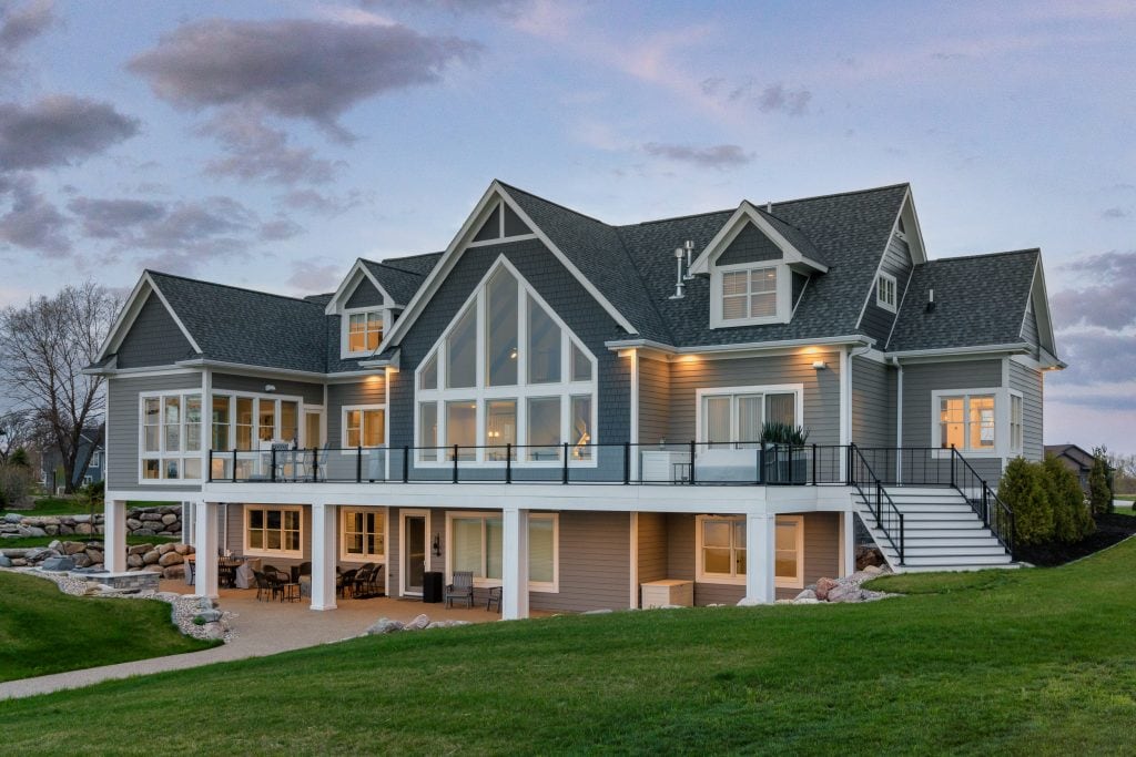 Crystal Lake 10 Rear exterior with balcony and patio seating.