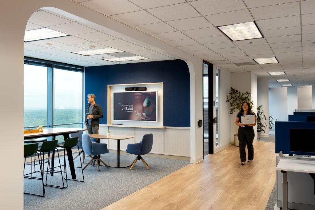 Capgemini Atlanta 7 Small meeting space with a bright blue accent wall and chairs.