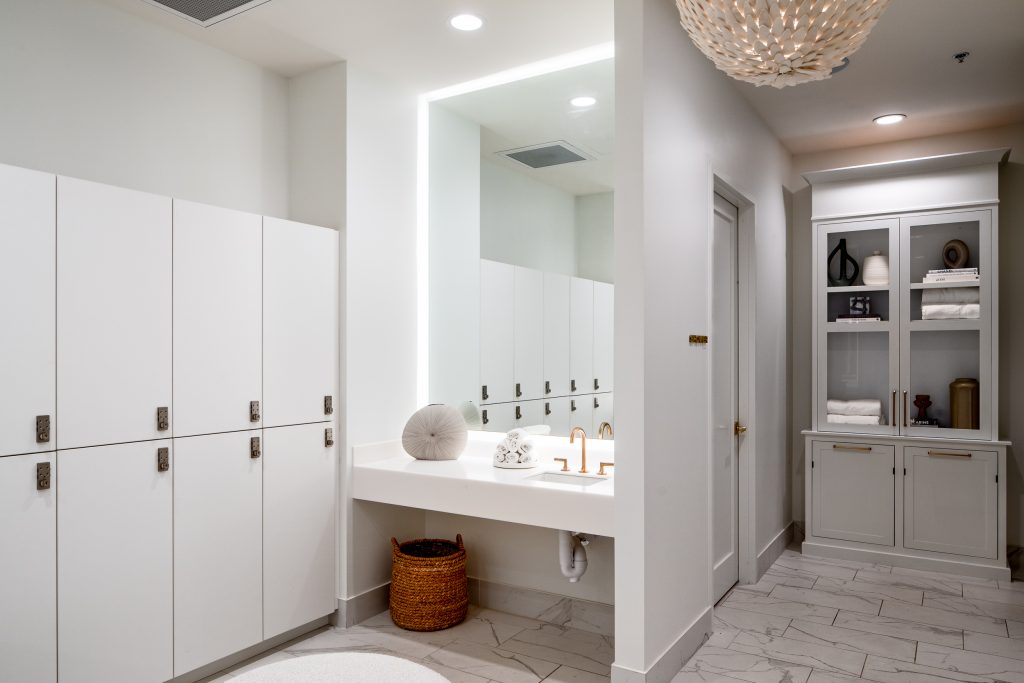 Brio 8 Locker room with spa-inspired details, including marble floors and white cabinetry.