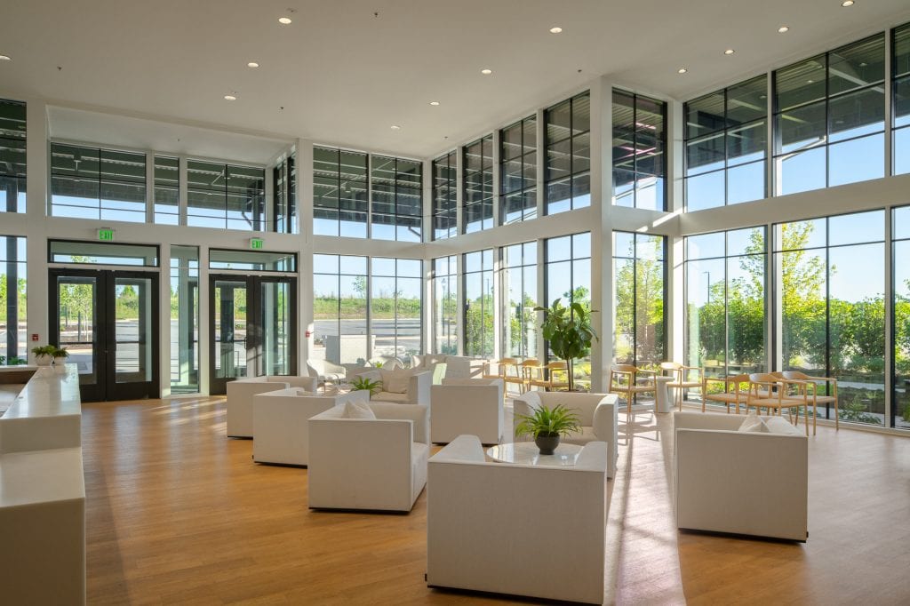 Brio 5 Spacious lobby with natural light and glass panels.