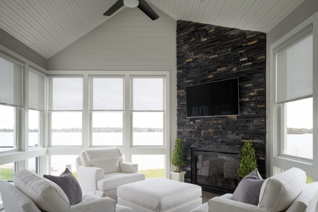 Crystal Lake 4 Bright sunroom with lake view and stone fireplace