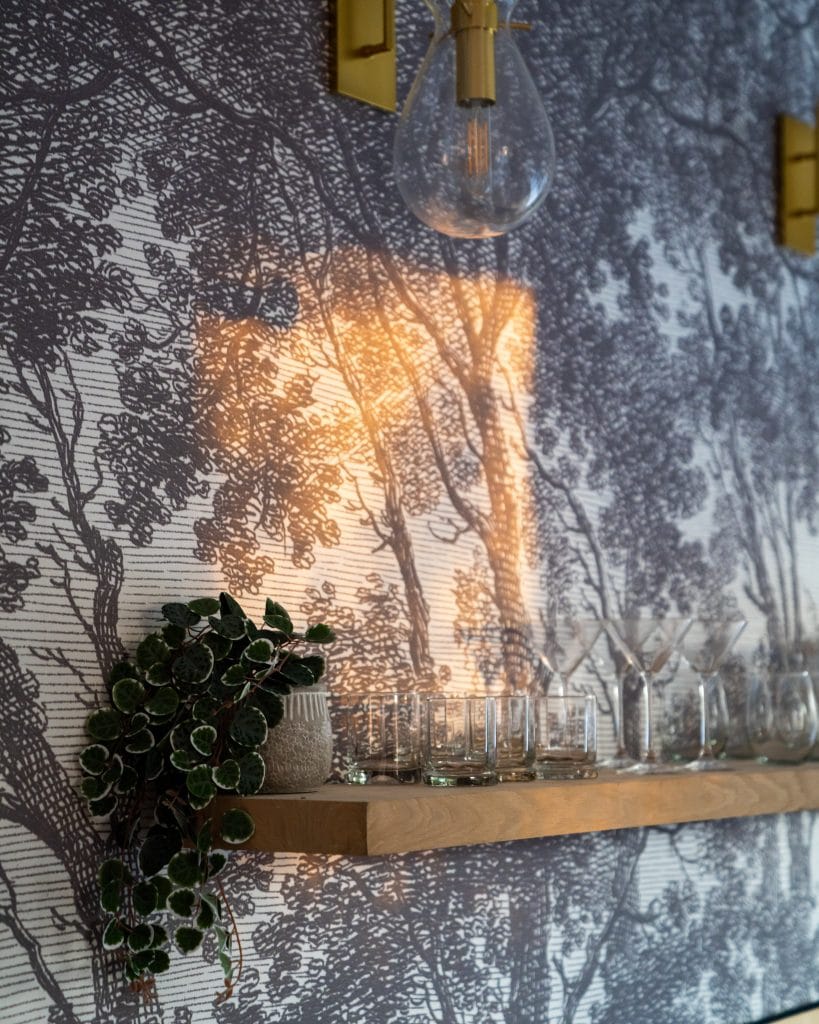 Eastside 3 Wall shelf with vintage glassware and textured wallpaper.