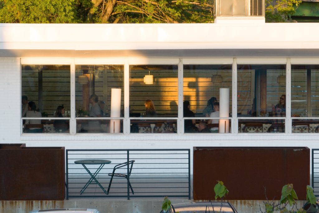 Golden Pony 17 Street-level view of bar interior through large glass windows.