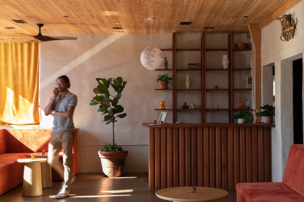 Golden Pony 3 Mid-century inspired bar lounge with wooden textures and a welcoming atmosphere.