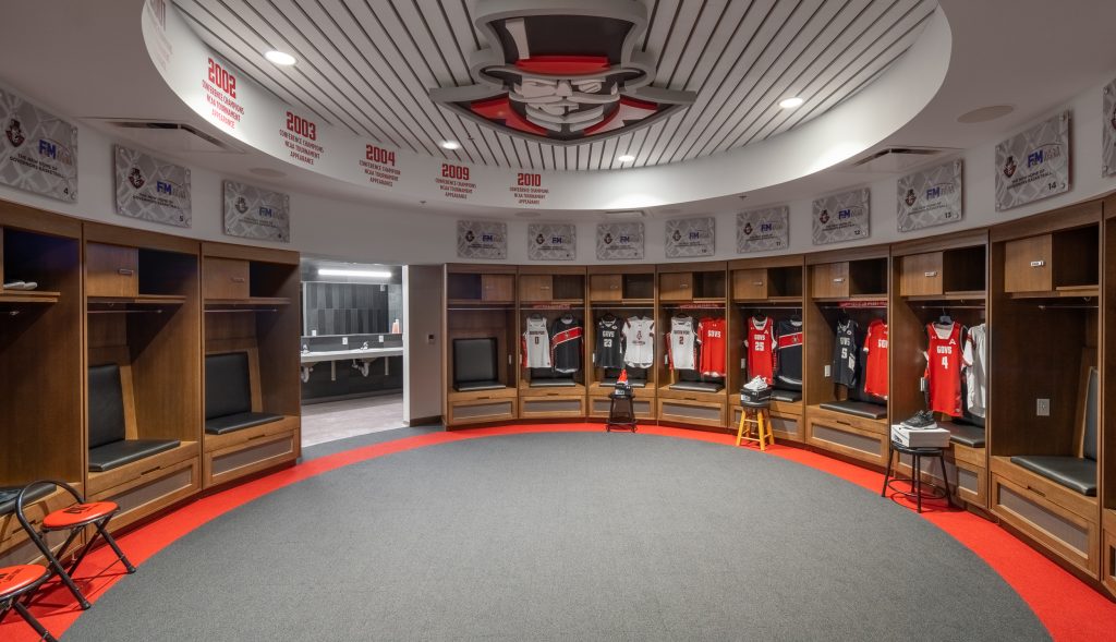 FM Bank Arena 10 Round locker room featuring wood paneling and built-in seating.