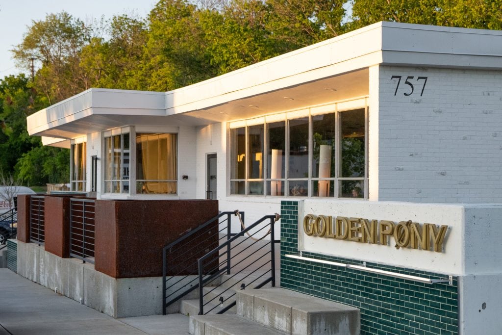 Golden Pony 20 Golden Pony bar exterior with glowing signage and modern architecture.