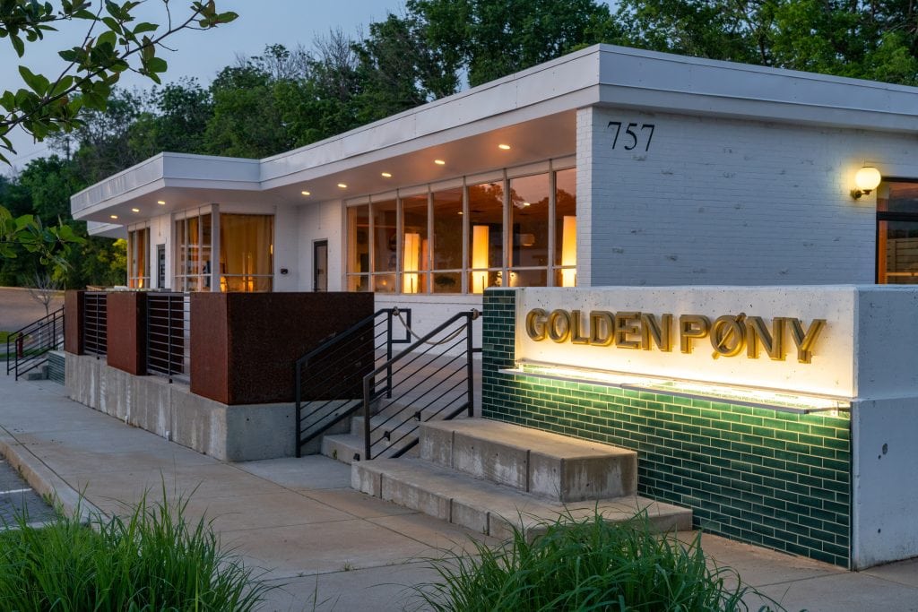 Golden Pony 22 Golden Pony entrance glowing at night with illuminated signage and modern design.