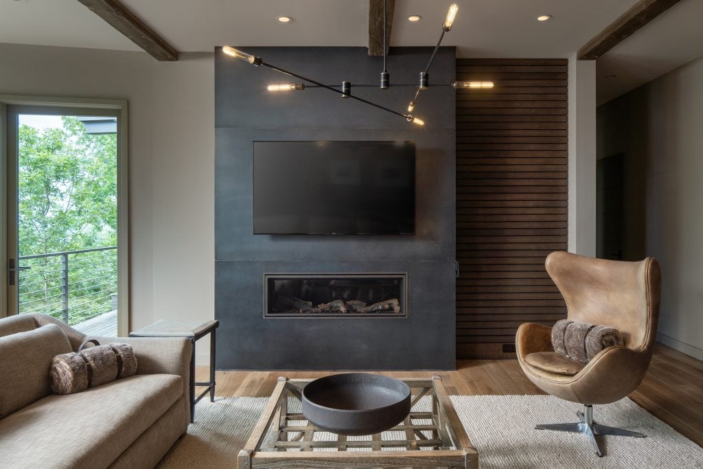 Laketown 8 Living room with fireplace, modern seating, and large windows.