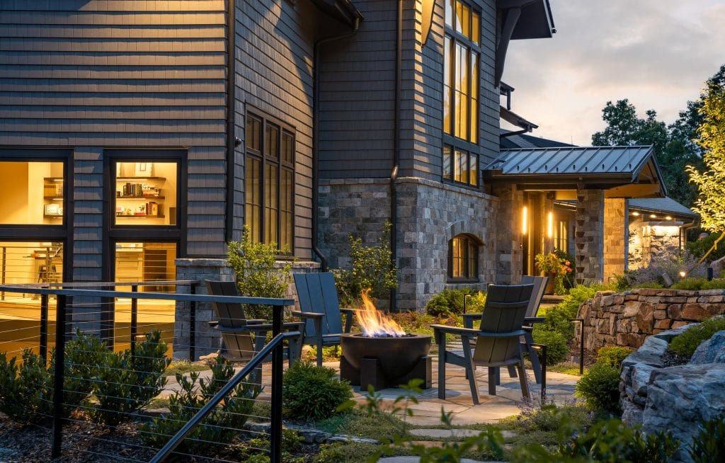 Laketown 9 Outdoor seating area with firepit, modern chairs, and illuminated exterior.