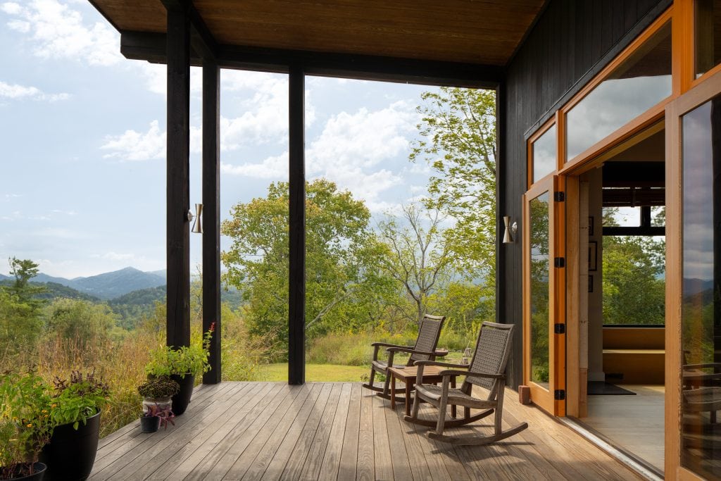 Freedom Cove 11 Covered porch with wooden rocking chairs overlooking mountain views.