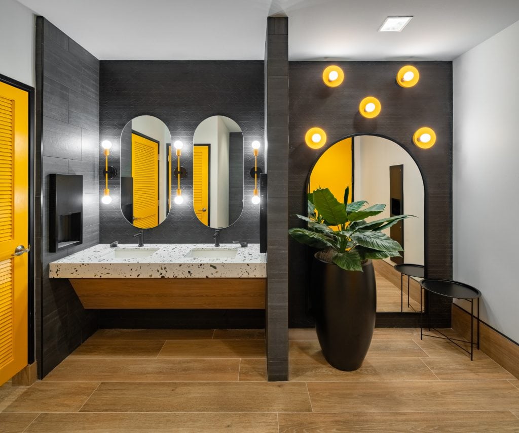 Lifeway 8 Contemporary restroom with black walls, yellow doors, and stylish lighting.