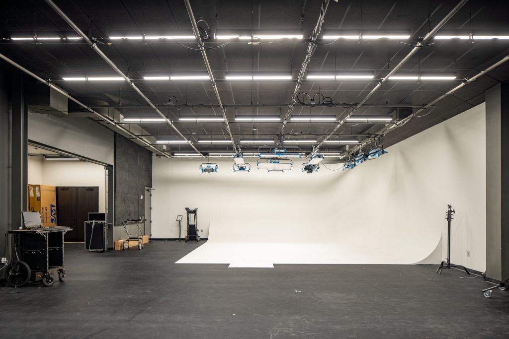 Lifeway 9 Large video production studio with a curved white backdrop and overhead lighting.