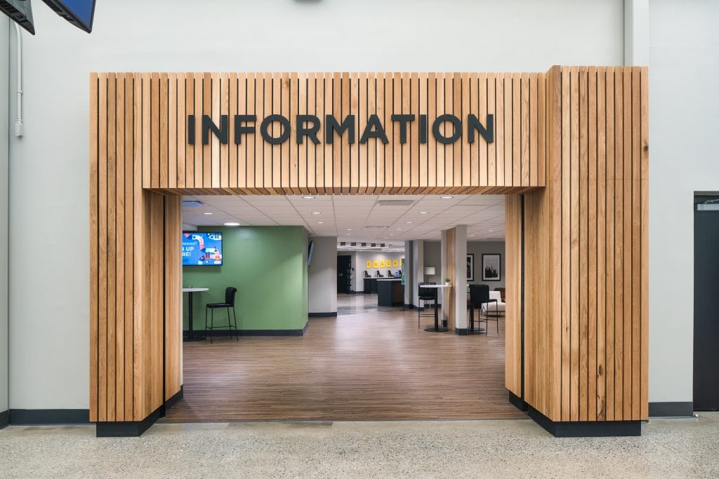 Long Hollow 10 Wooden slatted entrance to an information center with black signage and open walkway.