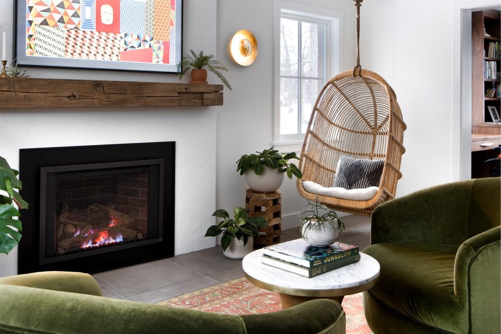 MINOR PARK MODERN 6 A modern fireplace mantel with a rattan hanging chair in a cozy living room.
