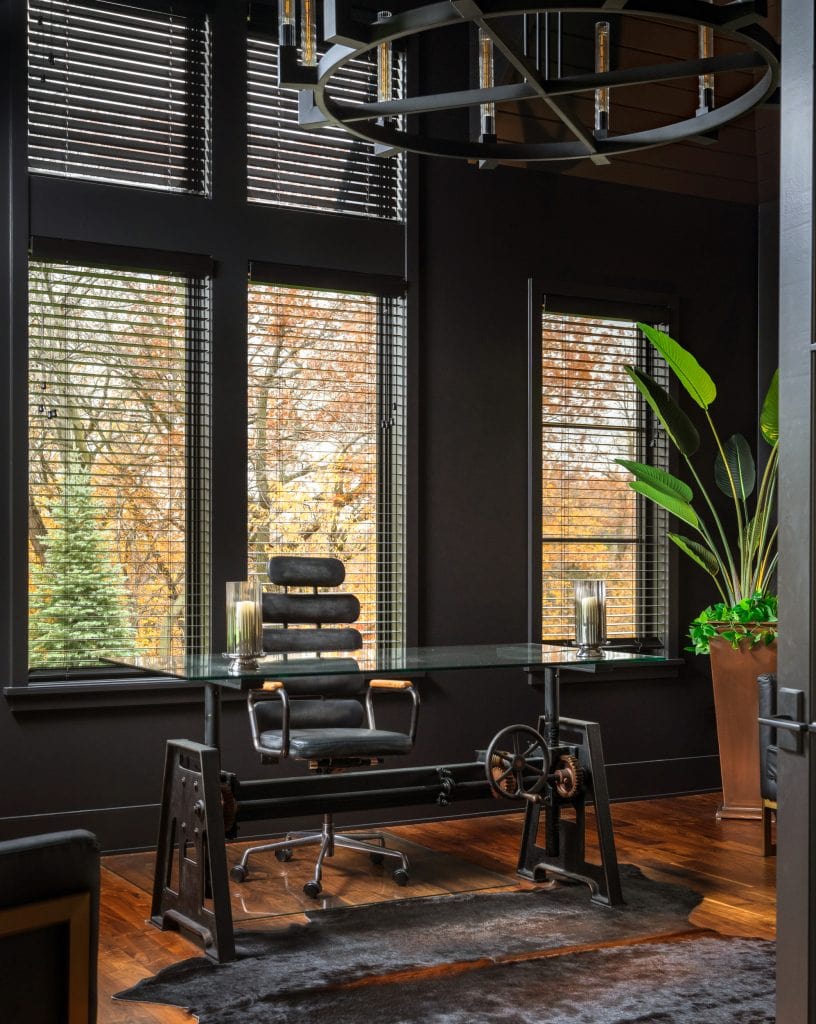 Marie 7 Luxury home office with dark walls, floor-to-ceiling windows, and a glass-top desk.
