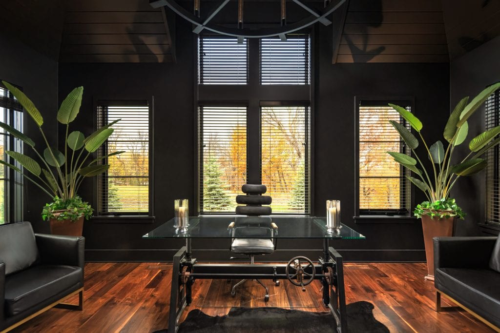 Marie 8 Luxury office with black walls, glass desk, and stylish furnishings.