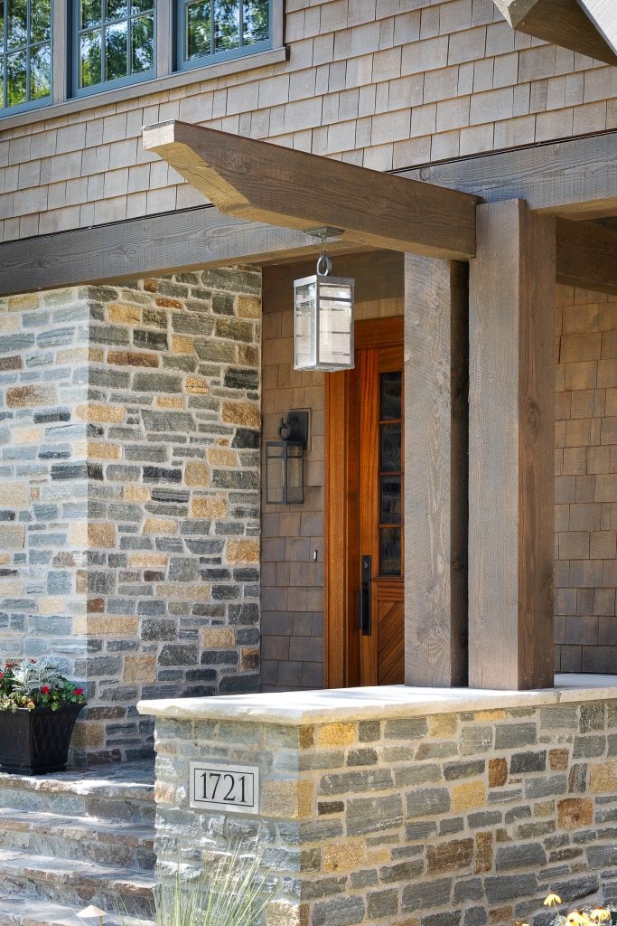 LAKE POLASKI 4 Wood post and beam entry porch with lantern light and stone accents.