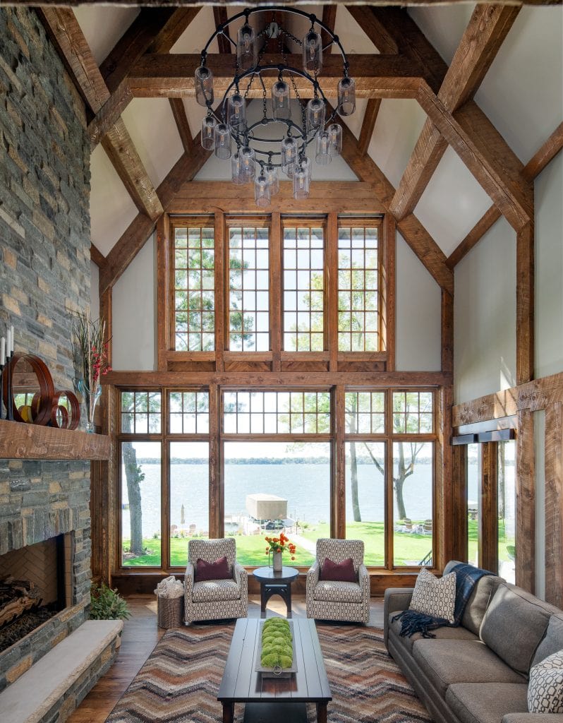 LAKE POLASKI 5 Living room with tall timber ceiling and lake view through windows.