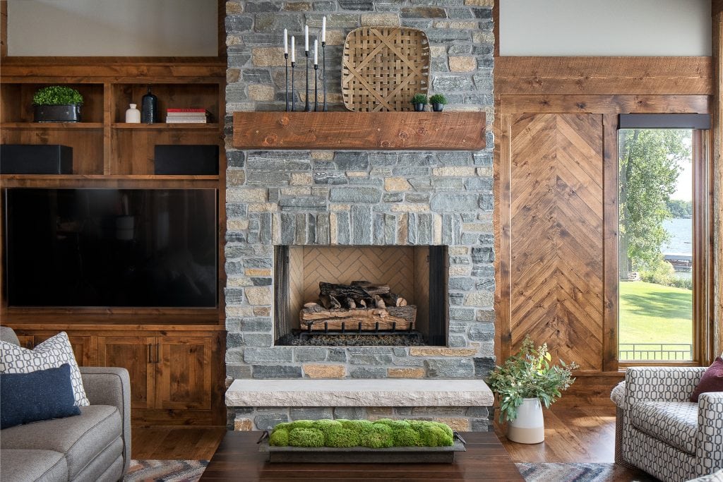 LAKE POLASKI 8 Stone fireplace with wood mantel flanked by built-in shelves.